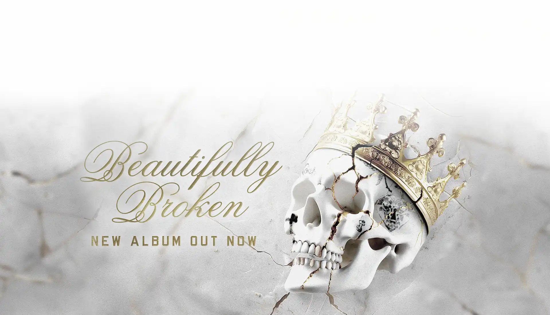 A white, cracked skull wearing a gold crown.